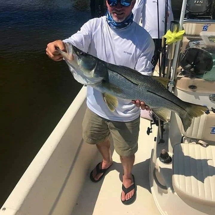 man white shirt big fish