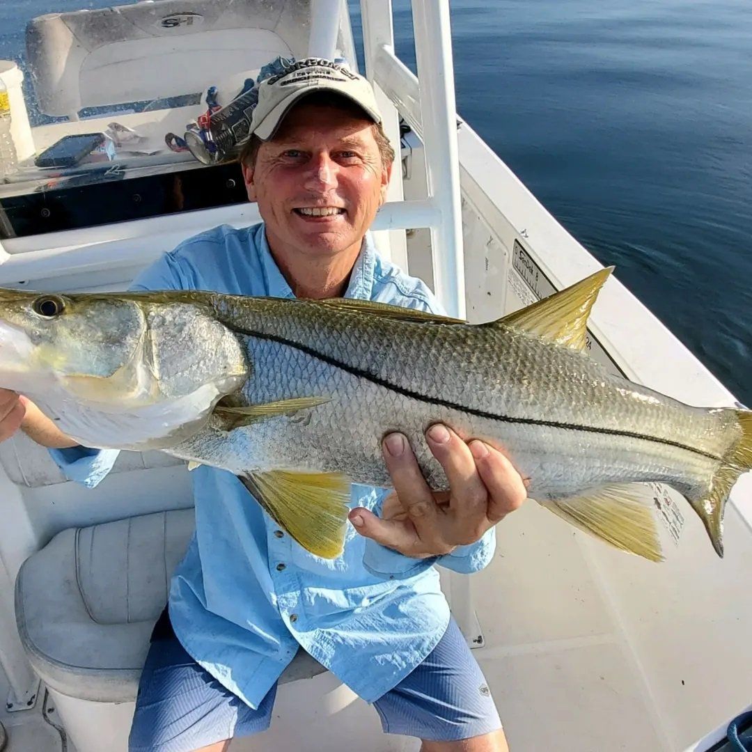 man blue polo shirt catch big fish