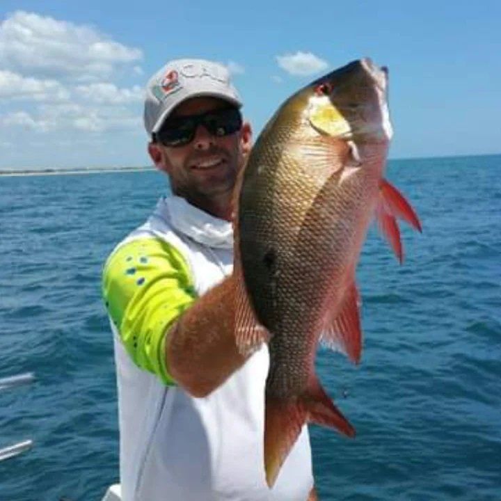 man white and yellow shirt catch fish