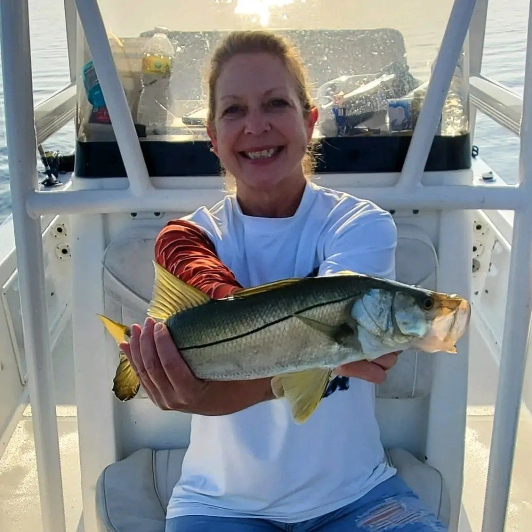 woman smiling caught fish