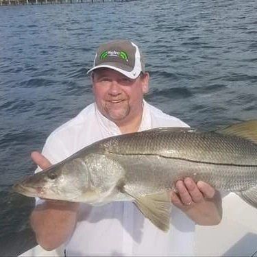 man on white shirt caught big fish