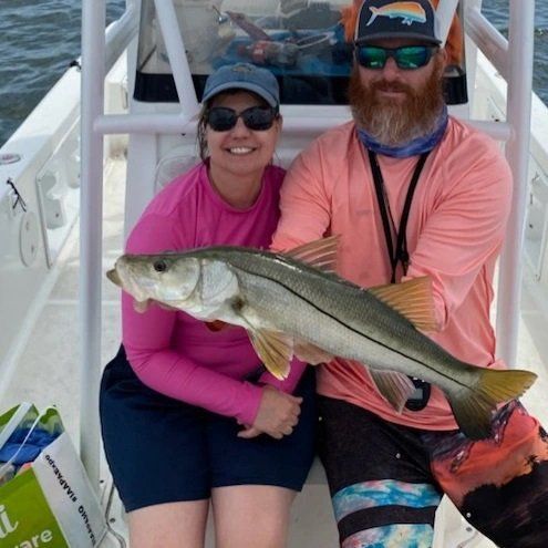 man and woman caught big fish