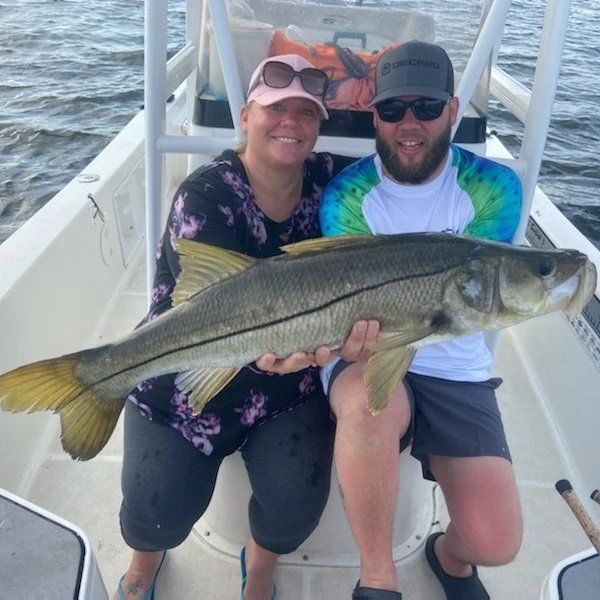 man and woman catch big fish