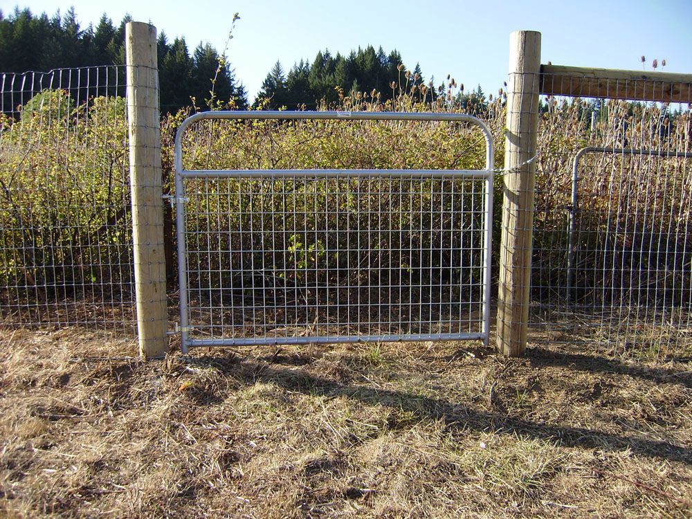 A fence with a gate in the middle of it.