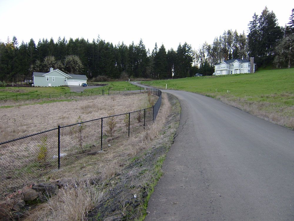 A road with a fence on the side of it