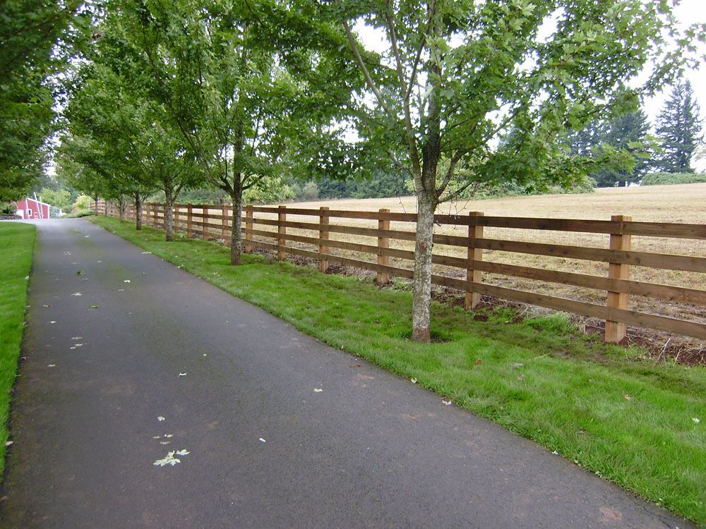 A wooden fence along the side of a road