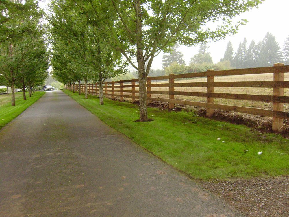 A wooden fence along the side of a road