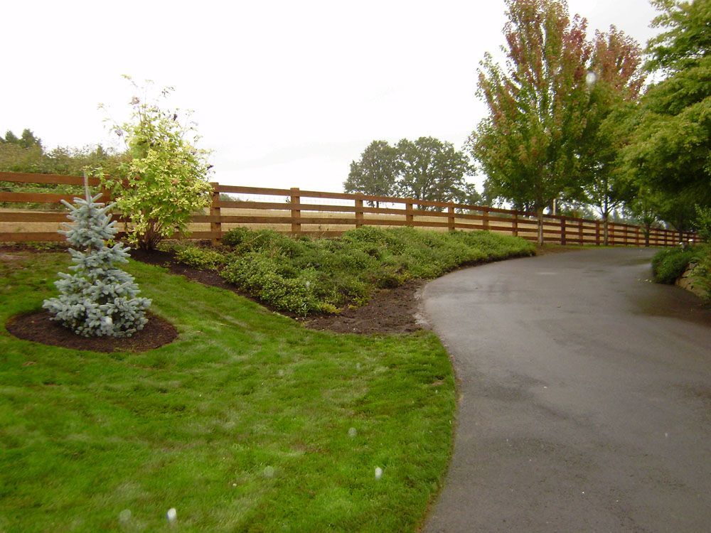 A wooden fence along the side of a road