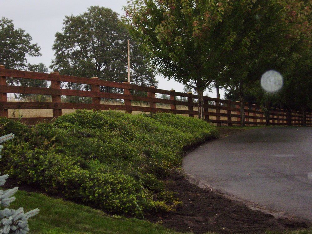 A wooden fence along the side of a road