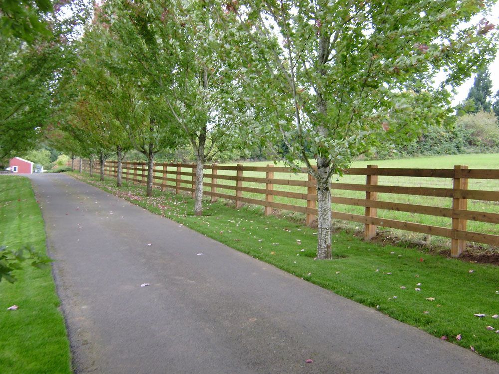 A wooden fence along the side of a road
