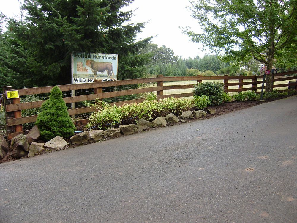 A wooden fence surrounds a road