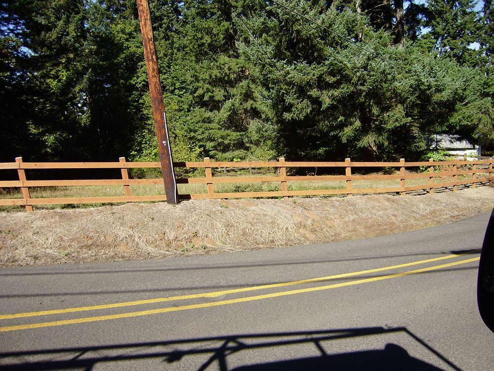A wooden fence along the side of a road