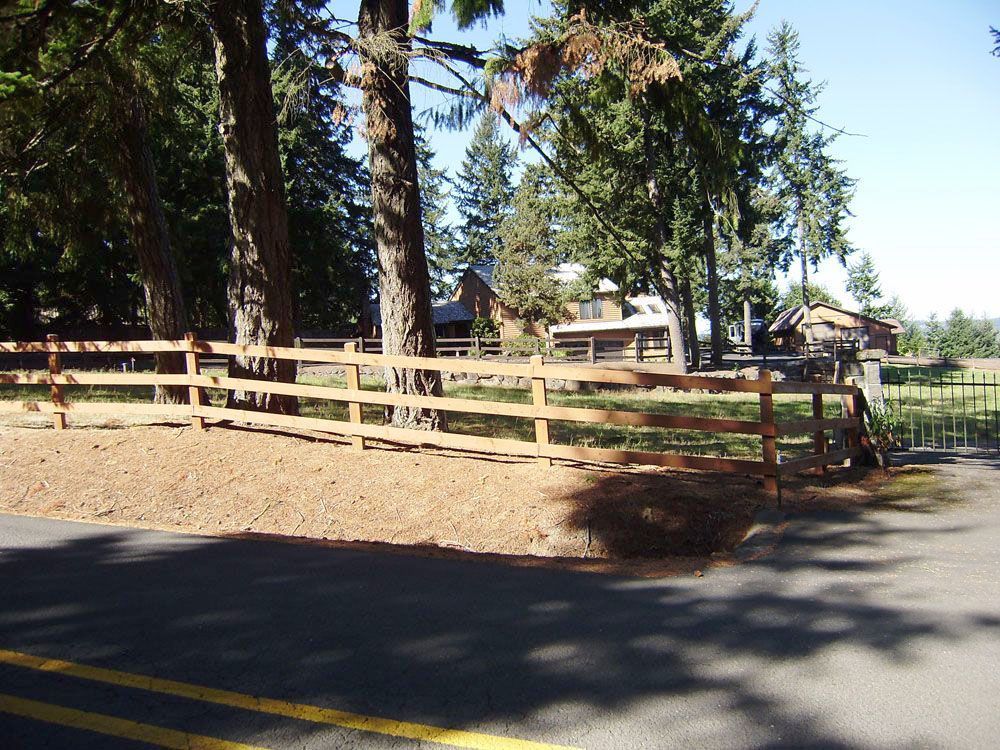 A wooden fence along the side of a road
