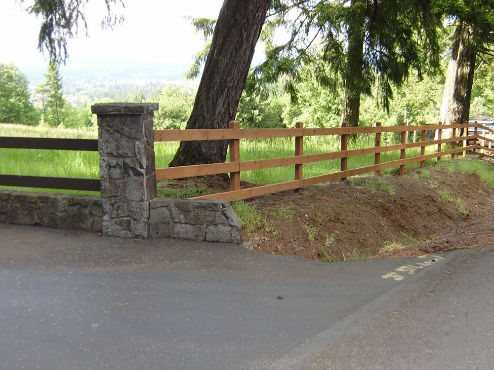 A well-built wooden fence along the side of a road