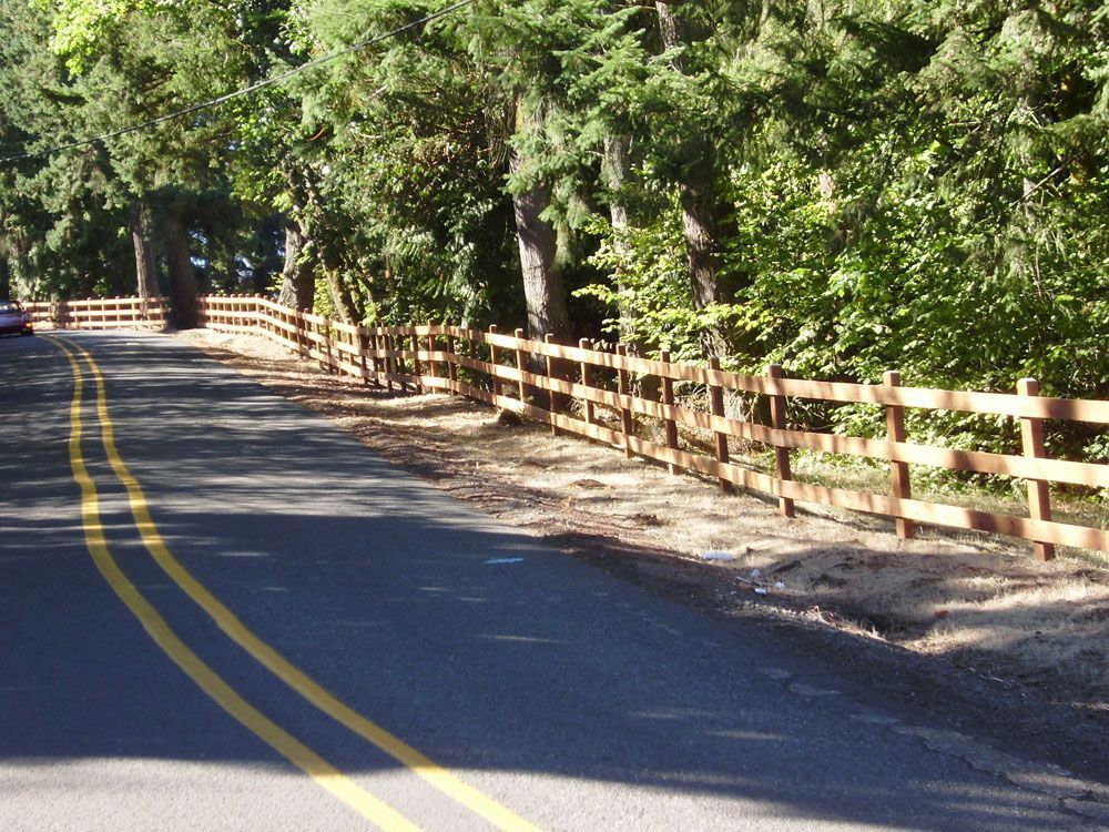 A road with a wooden fence on the side of it