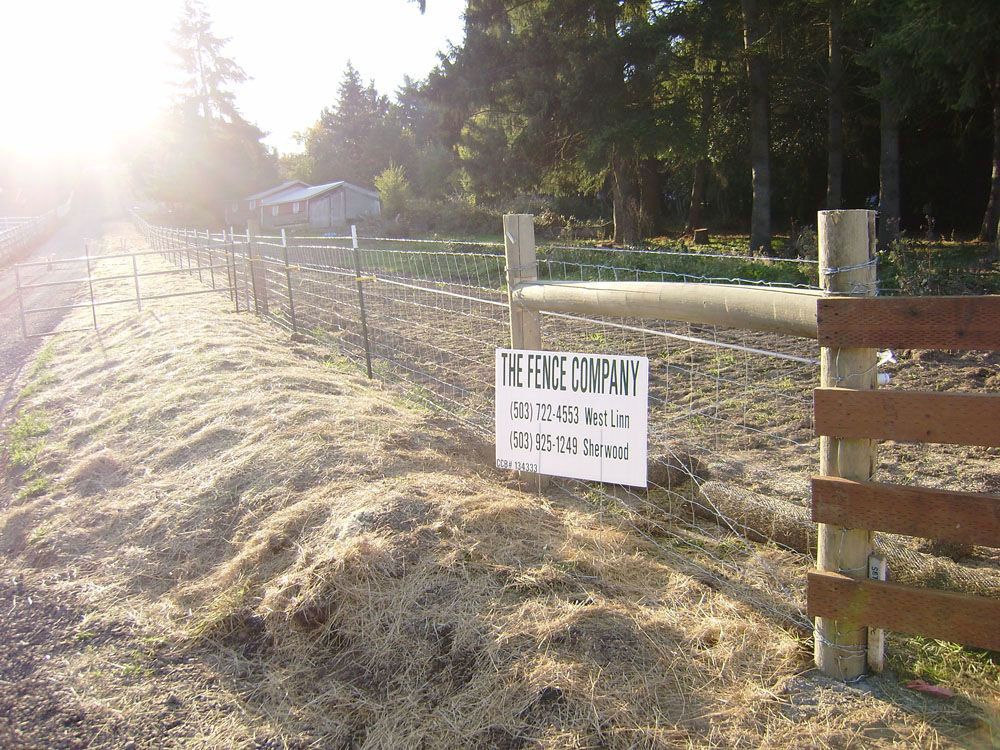 A wooden fence with a sign on it