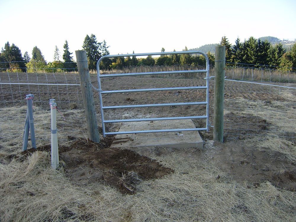 A metal gate is in the middle of a field