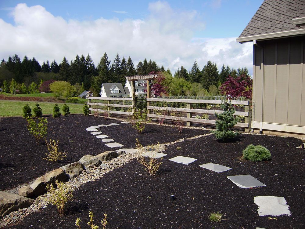 A house with a fence and a path in front of it