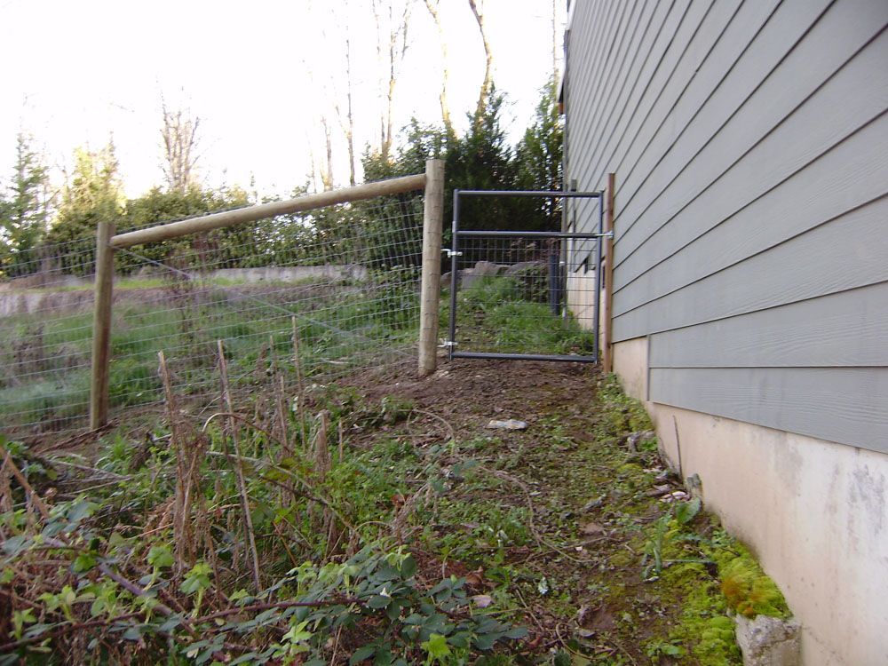 A house with a fence and a gate in front of it