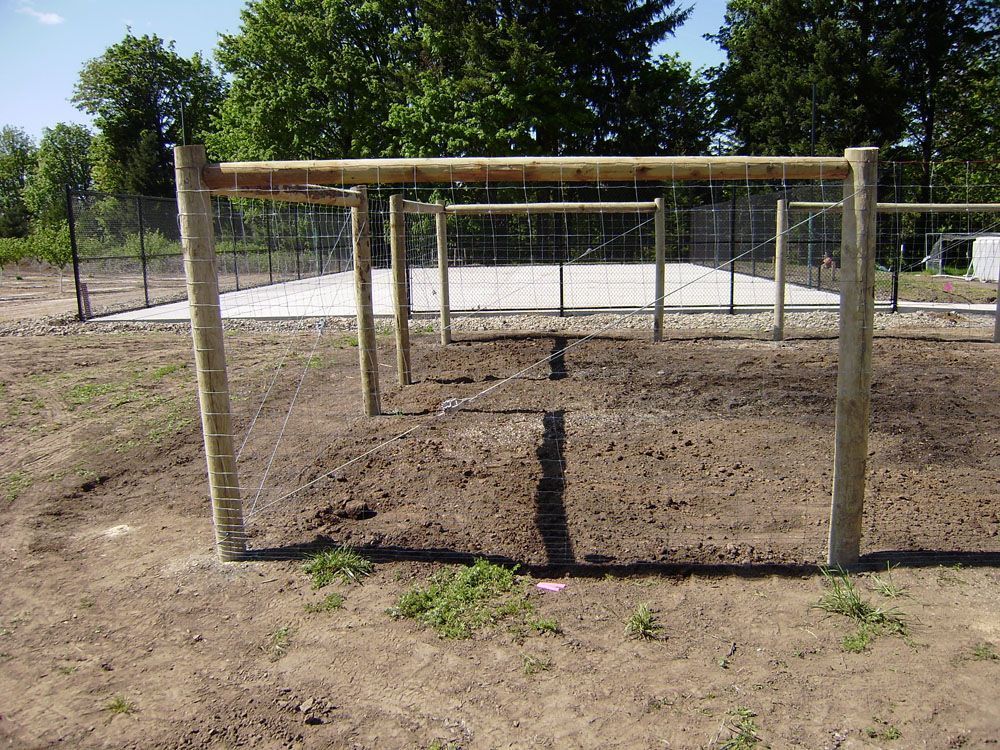 A wooden fence built in the middle of a dirt field