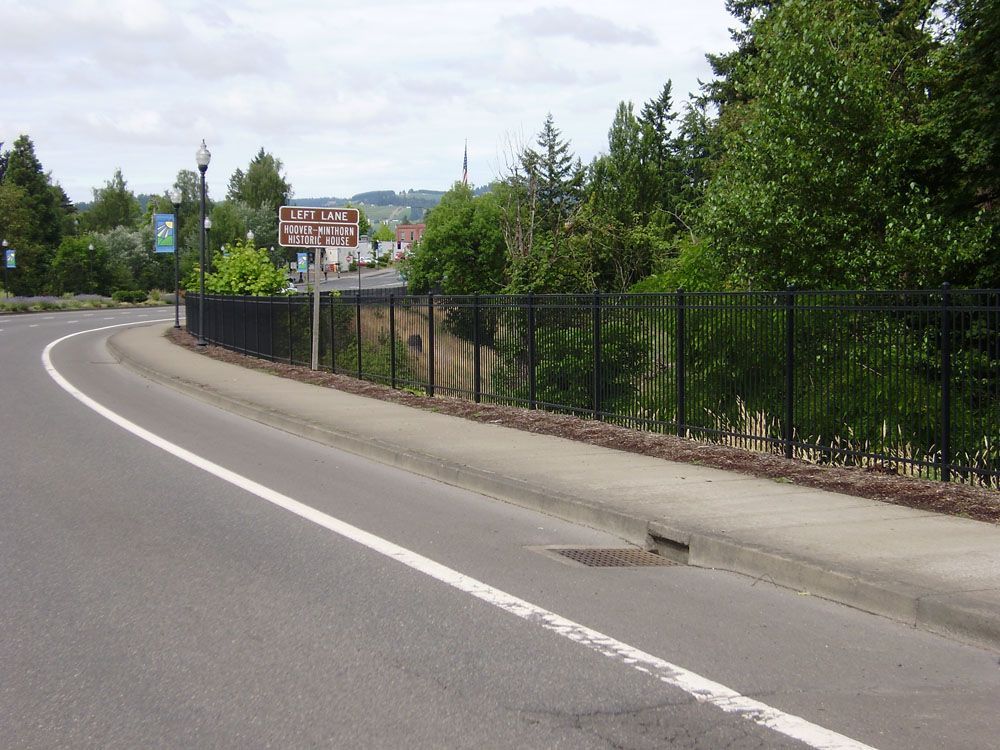 A road with a fence on the side of it