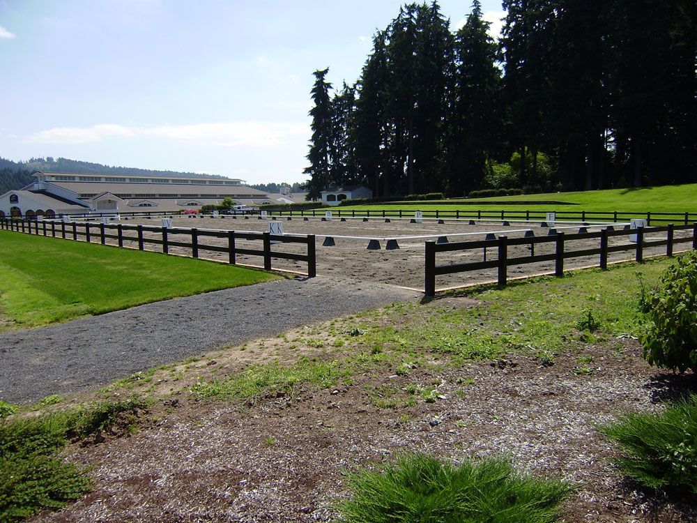 A fenced in area with a building in the background