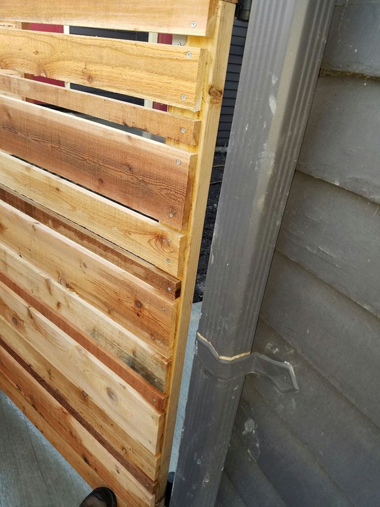 A wooden fence is sitting on the side of a building