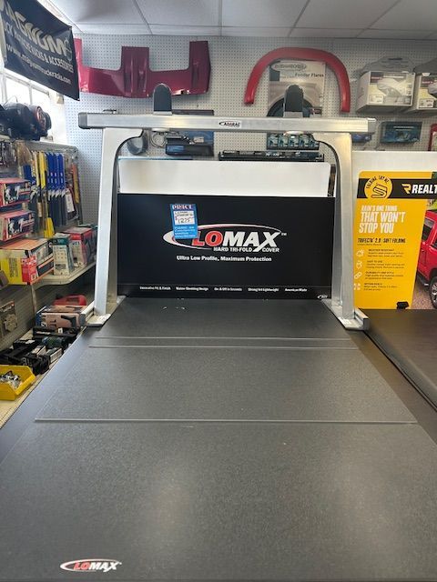 A treadmill in a store that says lomax on it