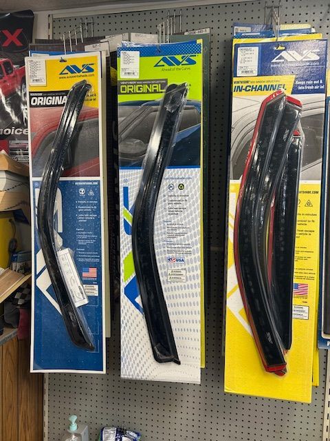 Three boxes of rain visors are hanging on a wall