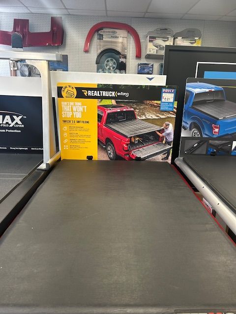 A truck bed cover is on display in a store