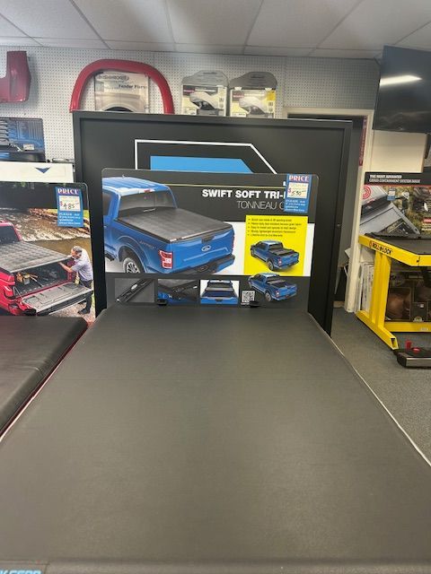 A truck bed cover is sitting on a table in a store.