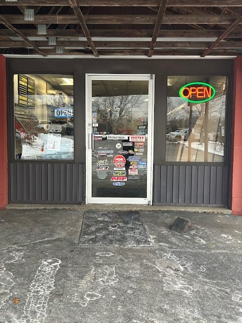 The front door of a restaurant with an open sign on it.