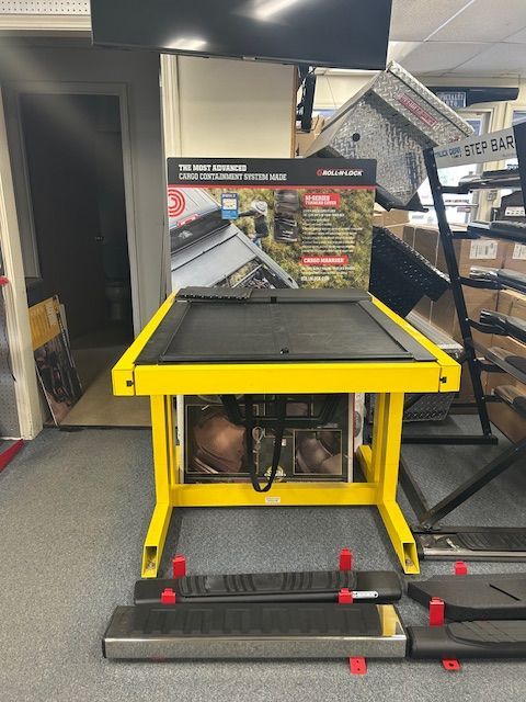 A yellow table in a room with boxes on the floor