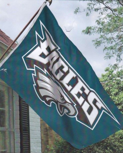 A philadelphia eagles flag is hanging from a pole