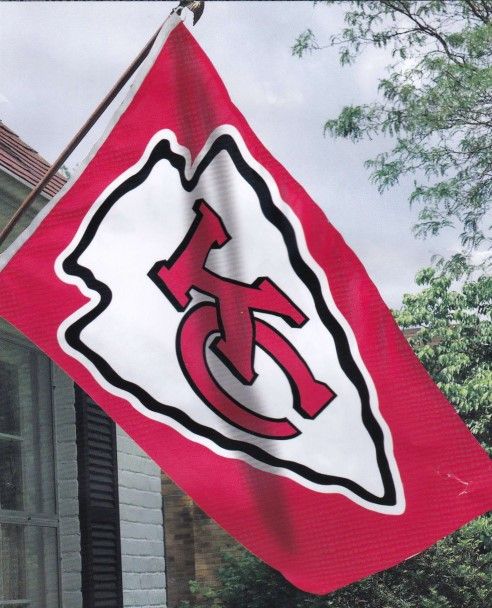 A red and white flag with a kc logo on it
