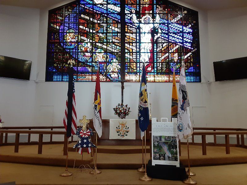 A church with flags and a stained glass window