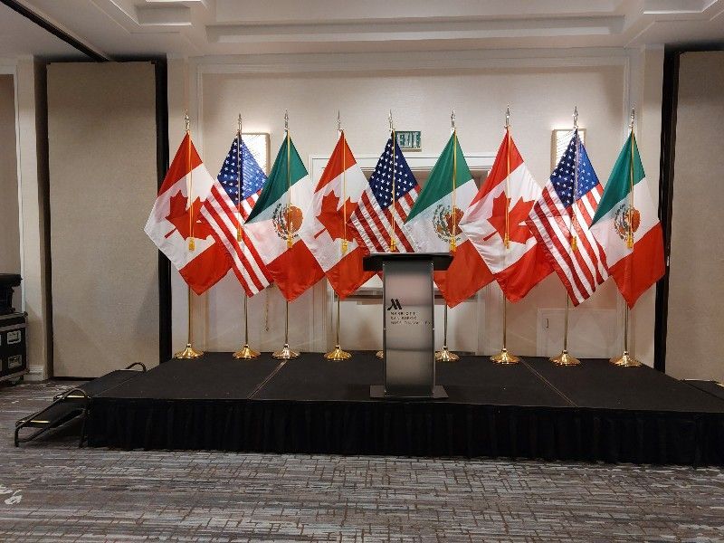 A room with a podium and flags on it