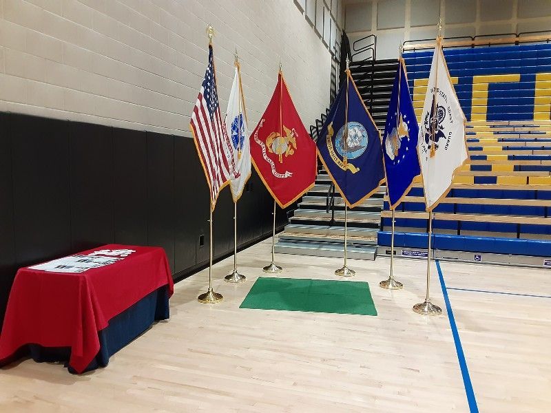 A row of flags are lined up in a gym