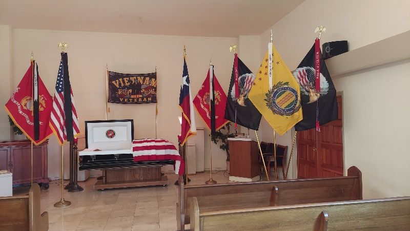 A church with a coffin and flags in it