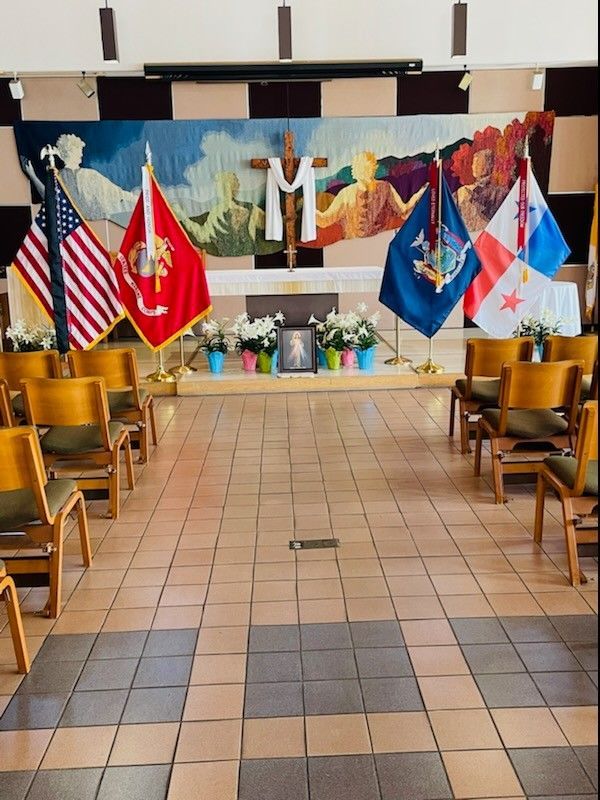 A church with flags and a cross on the wall