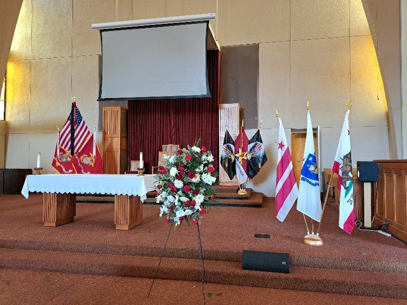 A church with flags and flowers on the altar