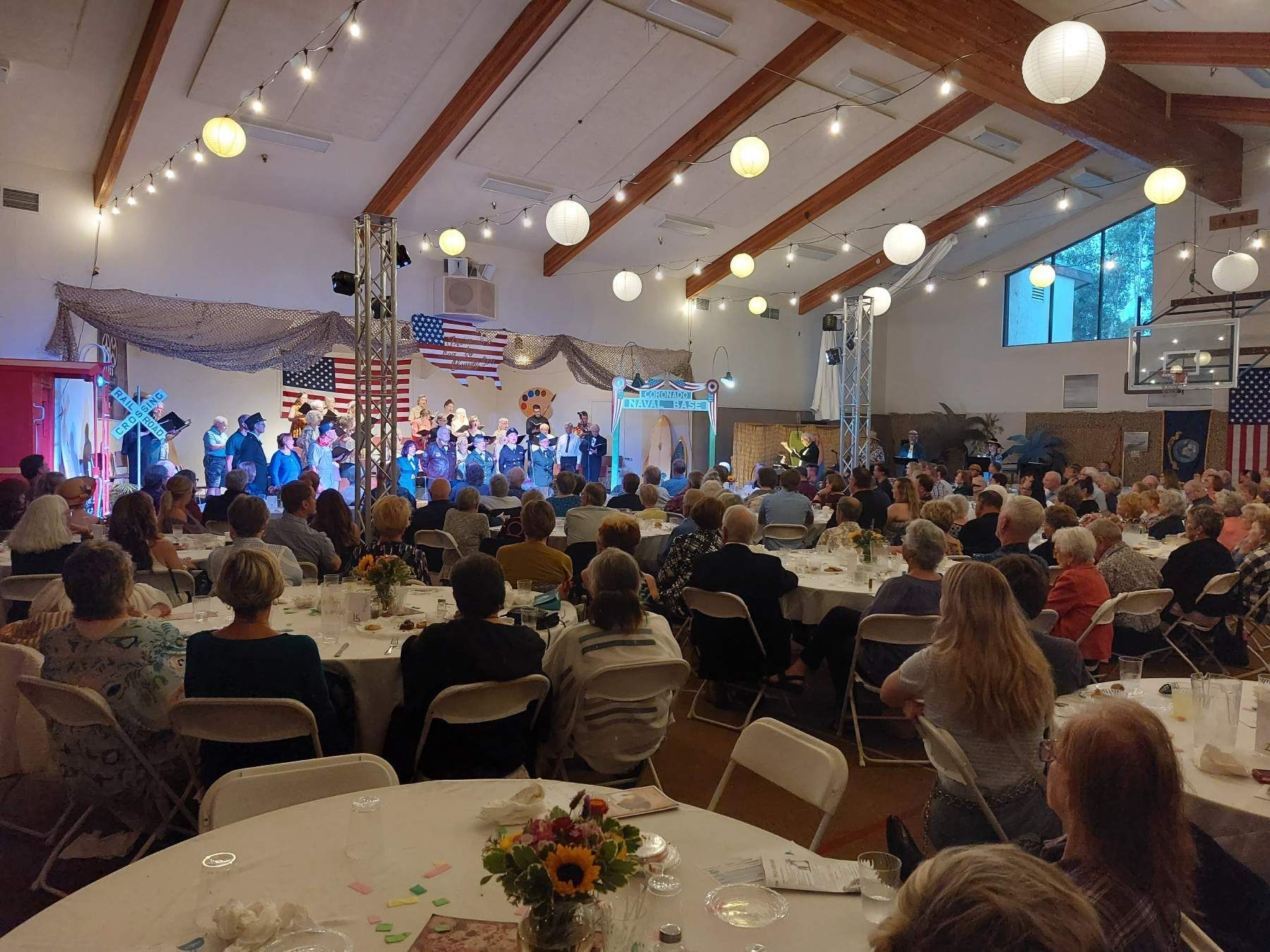 A large group of people are sitting at tables in a large room