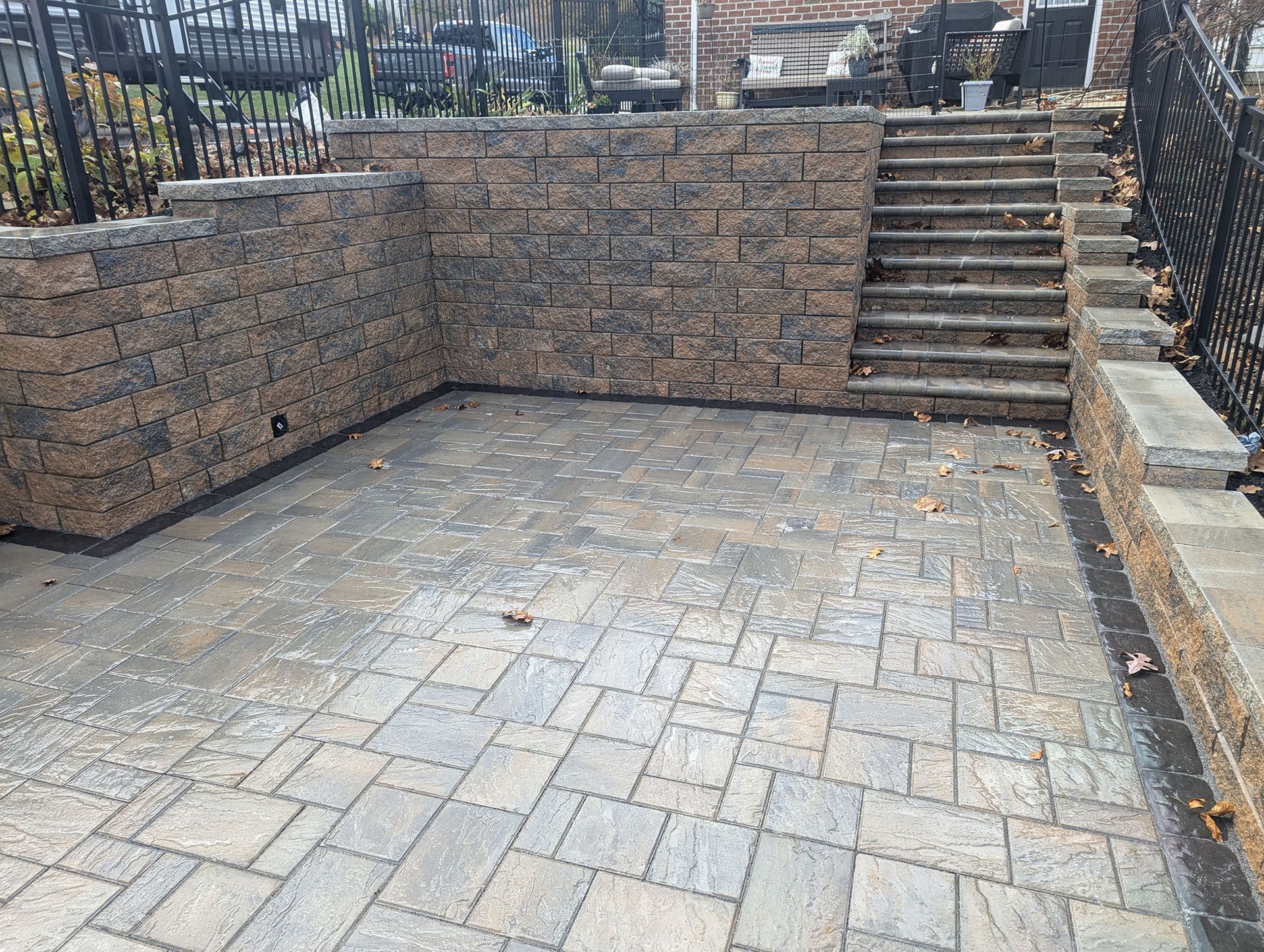 Stone patio with stone retaining walls and stairs.