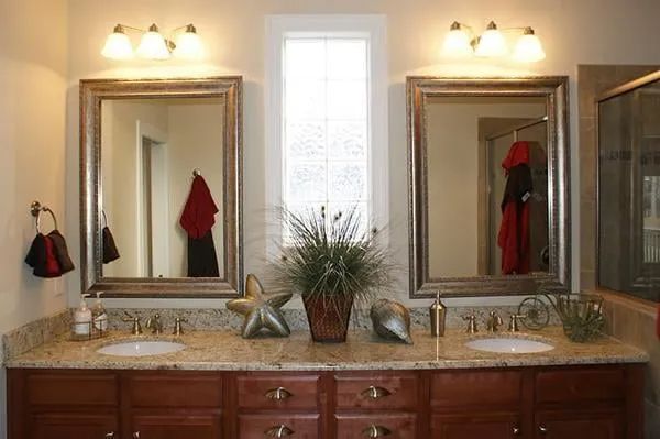 A bathroom with two sinks and two mirrors.