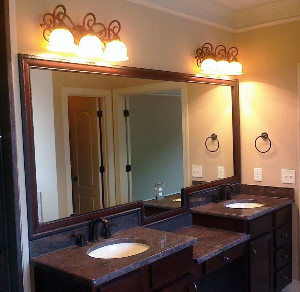 A bathroom with two sinks and a large mirror