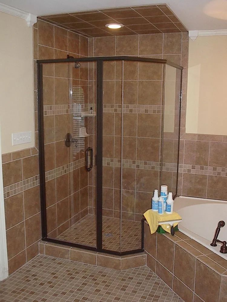 A bathroom with a walk in shower and a bathtub