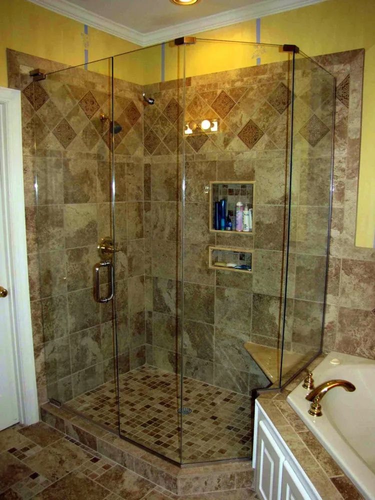A bathroom with a walk in shower and a bathtub.