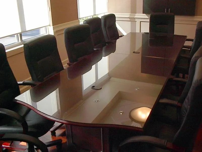 A conference room with a glass table and chairs