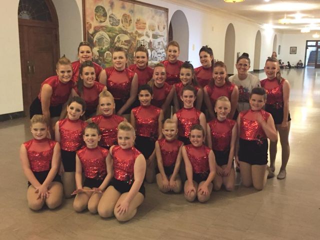 A group of young girls are posing for a picture