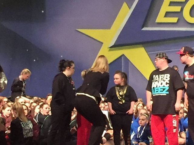 A group of people standing in front of a sign that says ec